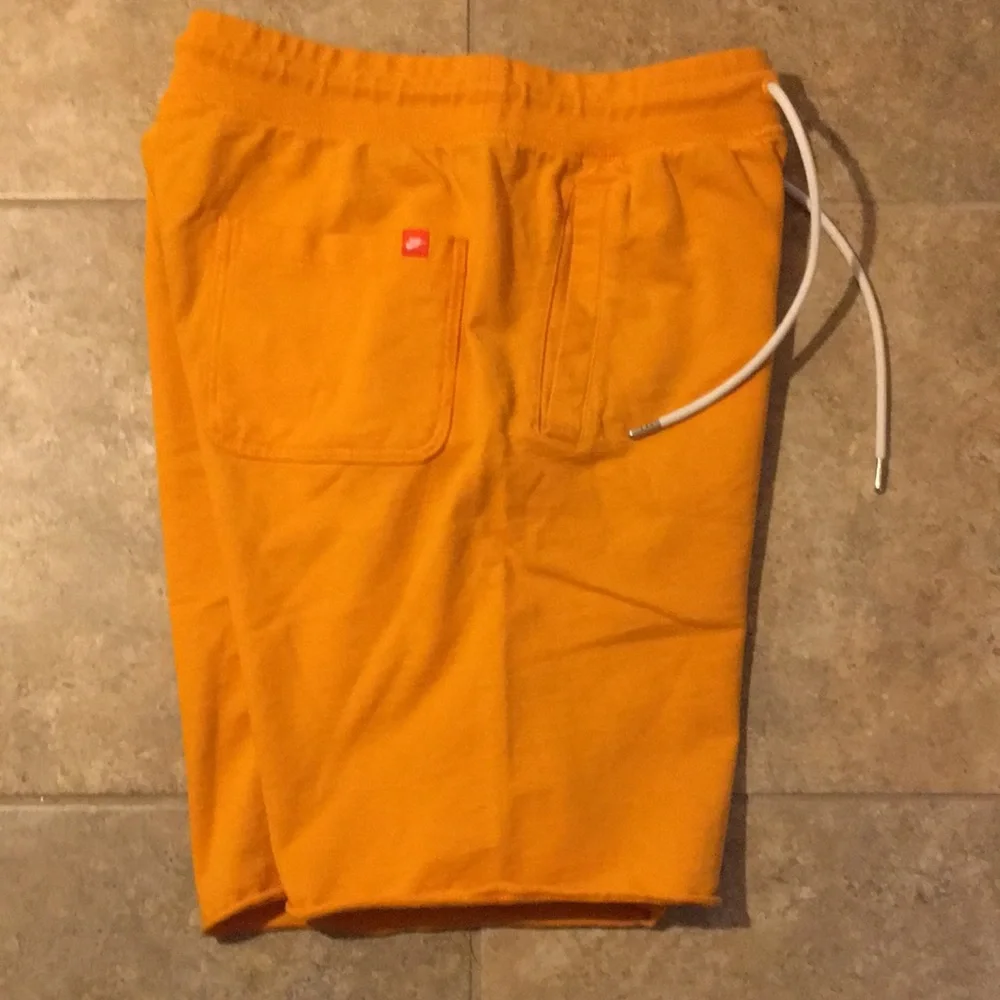 Nike Orange Men's Athletic Shorts with White Logo